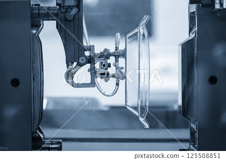 The plastic kitchen wear parts production process by injection machine in the light blue scene. The plastic kitchen wear parts production process by injection machine in the light blue scene. 125508851