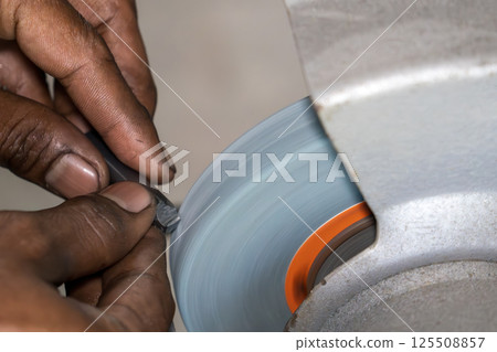 The lathe tool regrind process by manual operation by machine operator. 125508857