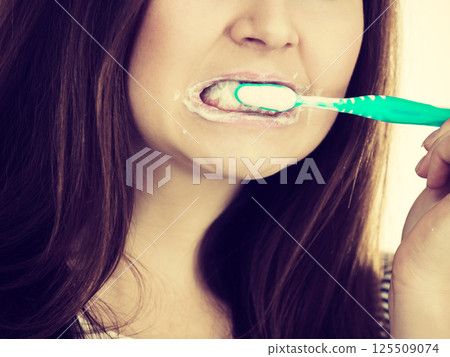 Woman brushing cleaning teeth. Woman brushing cleaning teeth. 125509074