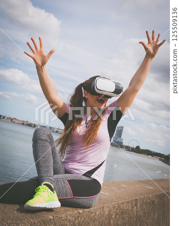 Woman wearing VR outside 125509136