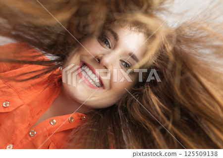 Happy positive woman with long brown hair 125509138