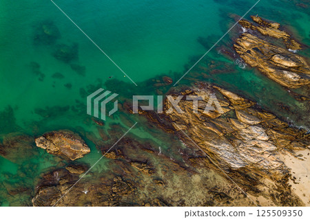 Top view seashore waves nature background,Amazing waves crashing on rocks seascape view 125509350