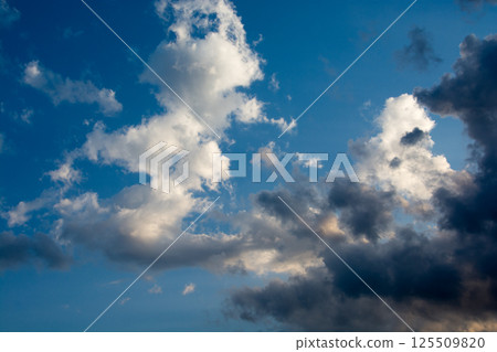 Clouds reflecting the sunlight in the blue sky 125509820