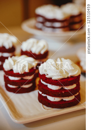 Red Velvet Mini Cakes with Whipped Cream Topping Red Velvet Mini Cakes with Whipped Cream Topping 125510459