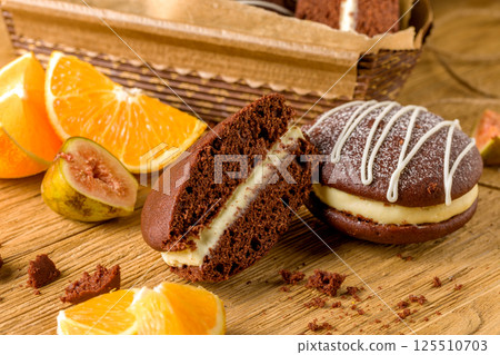 Whoopie pie with orange cream. Delicious homemade dessert Whoopie pie with orange cream. Delicious homemade dessert 125510703