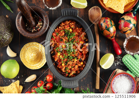 Mexican Beef Chili Con Carne with Ingredients and Tequila on Rustic Table 125511906