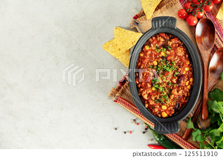 Mexican Chili Con Carne with Corn Chips, Peppers, and Tomatoes 125511910