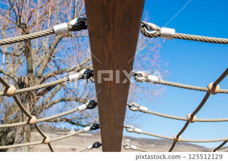 Blue sky with trees and beam with iron binding for exercise and sport.  125512129