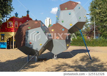 Climbing structures providing fun and challenges in playground setting 125512326