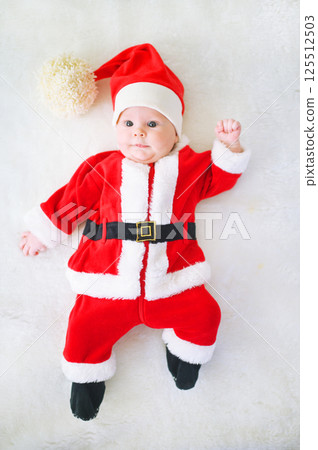 cute baby dressed as Santa on a white background. 125512503