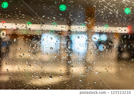 Rain drops on window with colorful blurred lights at night. 125513210