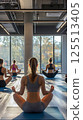 group of people doing yoga exercise in gym 125513405