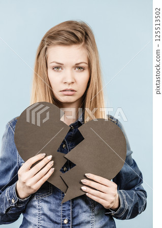 Young woman with broken heart Young woman with broken heart 125513502
