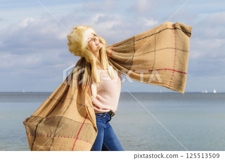 Fashionable woman on beach 125513509