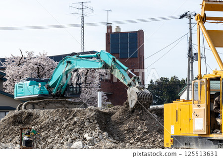Hydraulic excavator at demolition site 125513631