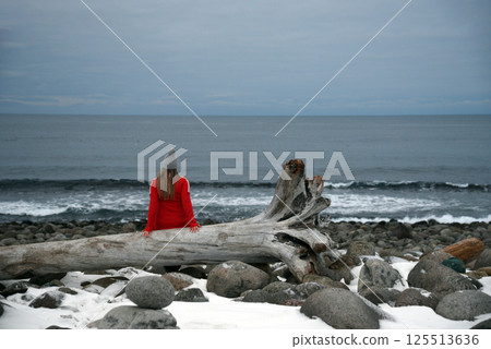 Individual Relaxing in Snowy Landscape Individual Relaxing in Snowy Landscape 125513636