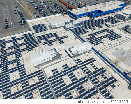 Shopping mall with solar panels on a roof. Aerial view Shopping mall with solar panels on a roof. Aerial view 125513825
