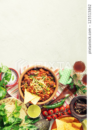 Mexican Beef Chili Con Carne with Nachos and Fresh Ingredients 125513862