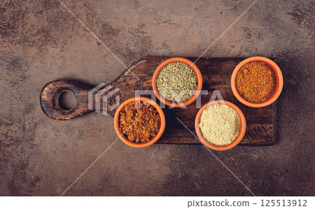 Georgian spices, in ceramic bowls, assortment, set of spices, utsho, adjika, Svan salt, ground coriander, top view, no people, Georgian spices, in ceramic bowls, assortment, set of spices, utsho, adjika, Svan salt, ground coriander, top view, no people, 125513912