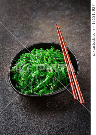 Chuka salad, made from fresh seaweed, with sesame dressing, served in a black bowl, with chopsticks, Chuka salad, made from fresh seaweed, with sesame dressing, served in a black bowl, with chopsticks, 125513927