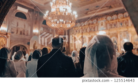 Christians standing during Easter service inside Orthodox church from back 125514643