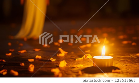 Warm candle light with scattered autumn leaves at night 125515665