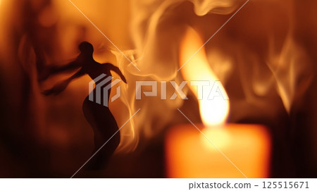 Silhouette of dancing woman in candlelit smoke captures elegance and mystery 125515671