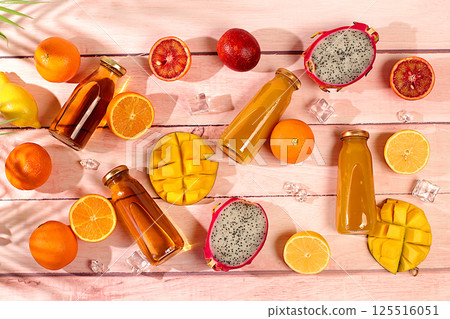 Summer exotic tropical fruits. Dragon fruit, pitahaya, mango, blood orange, lemons, kiwi, oranges and fresh juices, banner for a cafe or store, postcard for advertising an Asian market 125516051