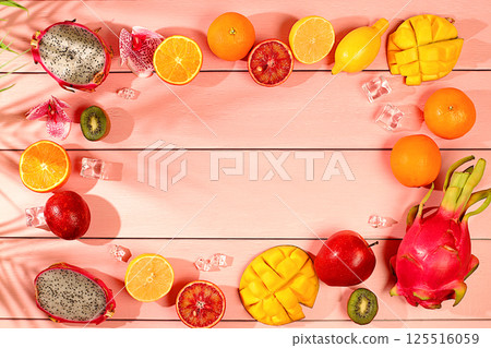 Summer banner with tropical exotic fruits with space for text. Dragon fruit, pitaya, mango, kiwi, avocado, apples, citrus and oranges on sunny table. Healthy vegan food for weight loss Summer banner with tropical exotic fruits with space for text. Dragon fruit, pitaya, mango, kiwi, avocado, apples, citrus and oranges on sunny table. Healthy vegan food for weight loss 125516059