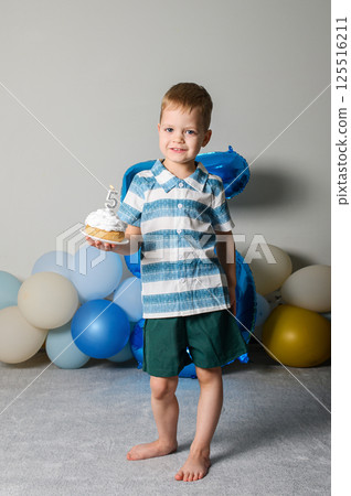 Happy Five Year Old Boy Celebrating Birthday with Cupcake and Candle Happy Five Year Old Boy Celebrating Birthday with Cupcake and Candle 125516211