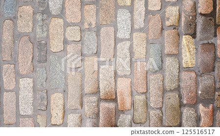 Wet cobblestone or brick stone road, view from above, can be used as texture 125516517