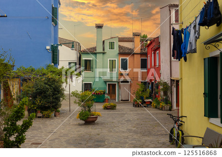 Charming colorful houses with sunset sky on Burano island Italy 125516868