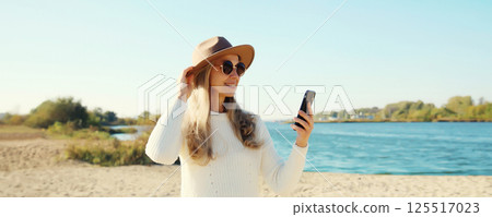 Travel, adventure, traveler woman taking selfie with phone on beach, girl using smartphone on coast 125517023