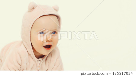 Happy cute baby crawling on the floor on white studio background Happy cute baby crawling on the floor on white studio background 125517034
