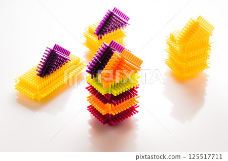 The elements of the children's construction set are presented in a full range of vibrant colors. The play-constructor parts are placed on a white background, creating a contrasting composition. 125517711