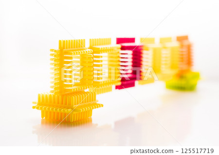 A children's construction set with bright parts looks attractive and inspires play. The elements of the play-constructor are made from safe materials. A children's construction set with bright parts looks attractive and inspires play. The elements of the play-constructor are made from safe materials. 125517719