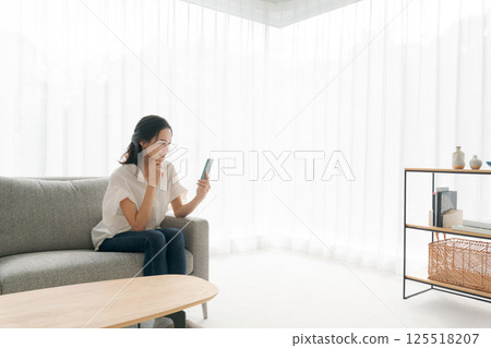 A woman sitting on a sofa and relaxing 125518207
