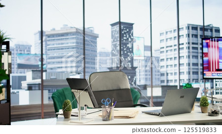 Modern work environment in a urban corporation downtown building, high end workspace with business analytics trends running on screen. Career development, office life concept. 125519833