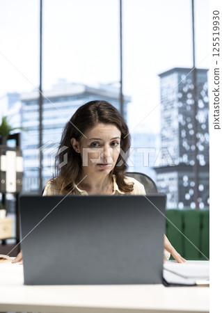 Ambitious determined entrepreneur negotiating with investors on online videoconference, asking for more funds to sustain a global expansion plan. Female director driven for career success. 125519930