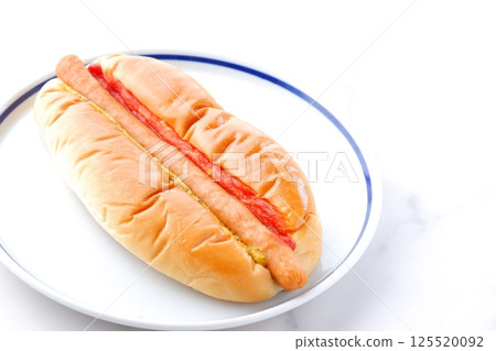 Chorizo sausage bun (hot dog) with mustard and ketchup 125520092