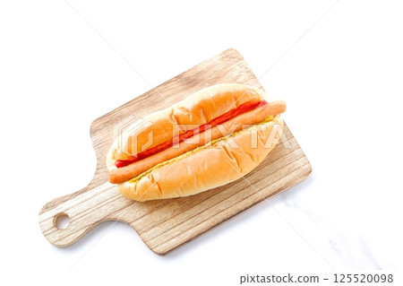 Chorizo sausage bun (hot dog) with mustard and ketchup 125520098