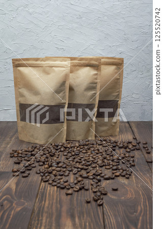 Freshly ground coffee beans on wooden table, perfect for coffee lovers. copyspace. 125520742
