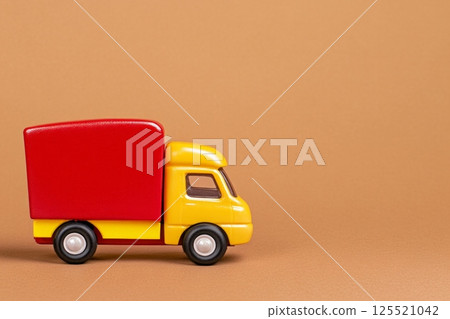 A playful retro fast-food-themed toy truck features bright red and yellow tones on a soft brown backdrop. This charming vehicle evokes nostalgia and whimsy, making it a delightful addition to any A playful retro fast-food-themed toy truck features bright red and yellow tones on a soft brown backdrop. This charming vehicle evokes nostalgia and whimsy, making it a delightful addition to any 125521042