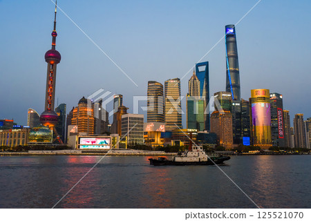 Shanghai, China - 1 April 2025: Editorial night skyline view of Pudong district at sunset across the Huangpu River, featuring the Oriental Pearl Tower and financial center Shanghai, China - 1 April 2025: Editorial night skyline view of Pudong district at sunset across the Huangpu River, featuring the Oriental Pearl Tower and financial center 125521070