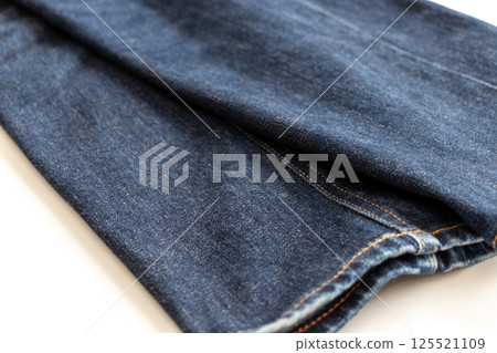 Blue jeans on a white table Blue jeans on a white table 125521109