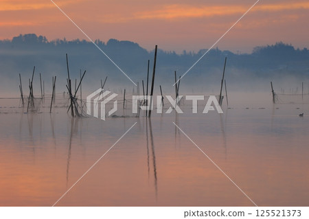 Morning glow reflected on the water surface Morning glow reflected on the water surface 125521373