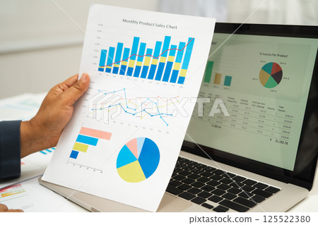 Asian business woman working with financial graph. Asian business woman working with financial graph. 125522380