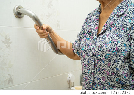 Asian elderly woman use toilet bathroom handle security, healthy strong medical concept. Asian elderly woman use toilet bathroom handle security, healthy strong medical concept. 125522382
