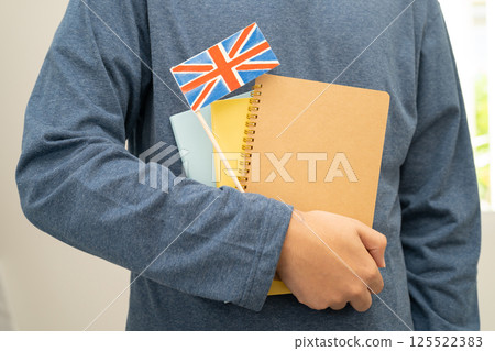 Learn English language, Asian teenage student hold book with flag in course at school. Learn English language, Asian teenage student hold book with flag in course at school. 125522383