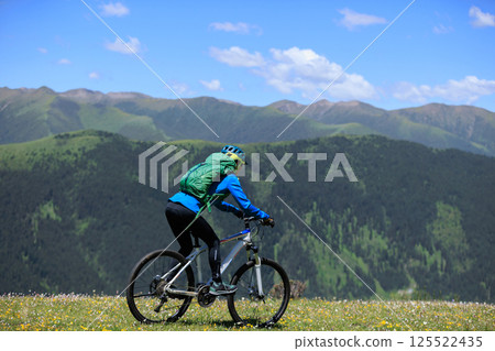 Riding mountain bike in the beautiful mountains Riding mountain bike in the beautiful mountains 125522435